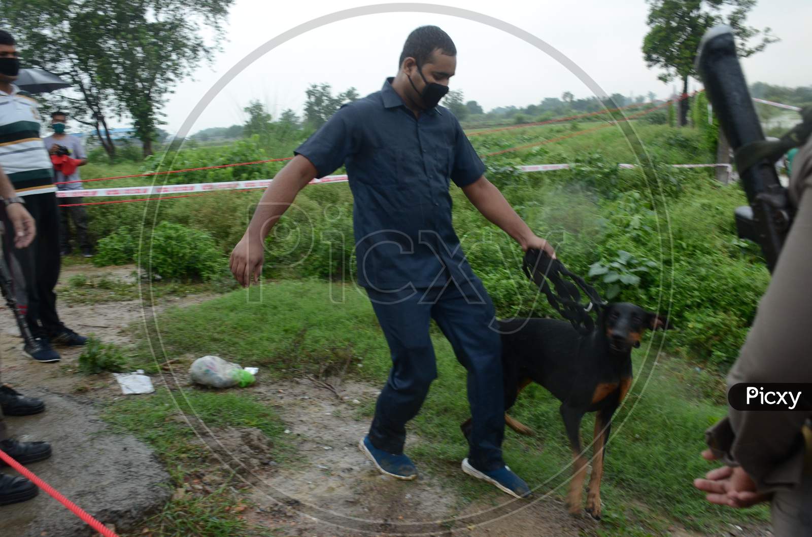 A police officer checks the area with the help of a police dog at the site of the encounter where gangster Vikas Dubey was killed when he tried to escape from police custody in Kanpur, Uttar Prades h on July 10, 2020