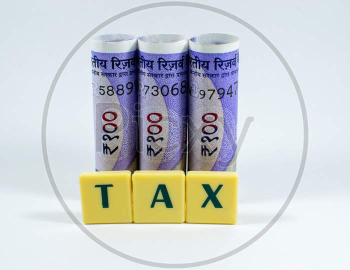 Tax word concept Image with new one hundred rupees of India