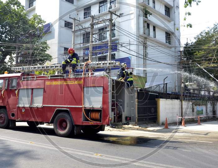 Fire-fighters spray disinfectants on streets