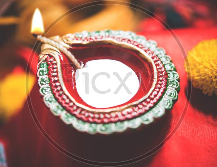 Diwali Diya, Sweets OR Mithai, Gift boxes and Crackers arranged over moody background
