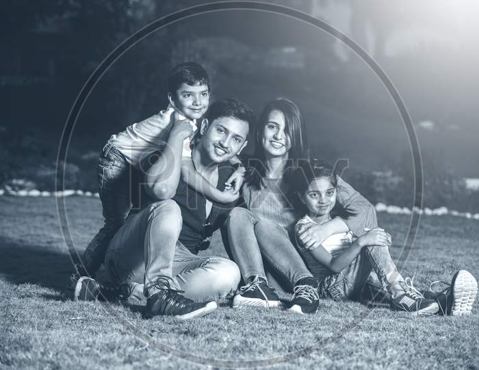 Portrait of Happy Indian/Asian Family sitting outdoor