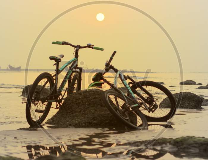 Bicycle In Background Beautiful Sea Beach Nature Sunset.