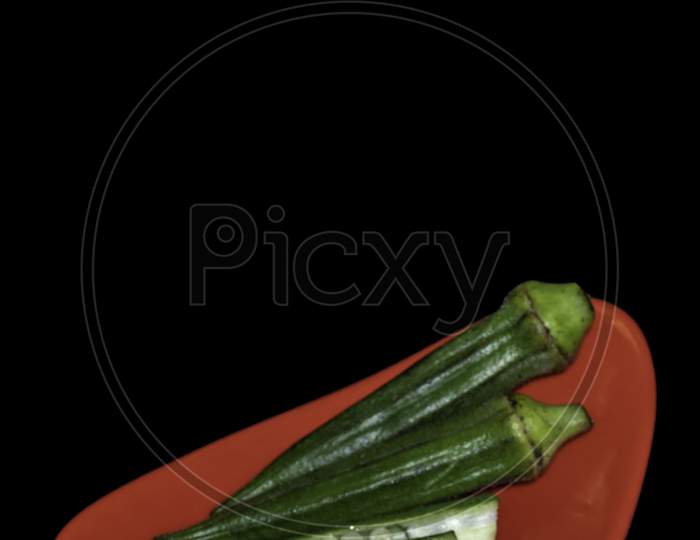 Red Plate of Lady Finger with seed Isolated in black background