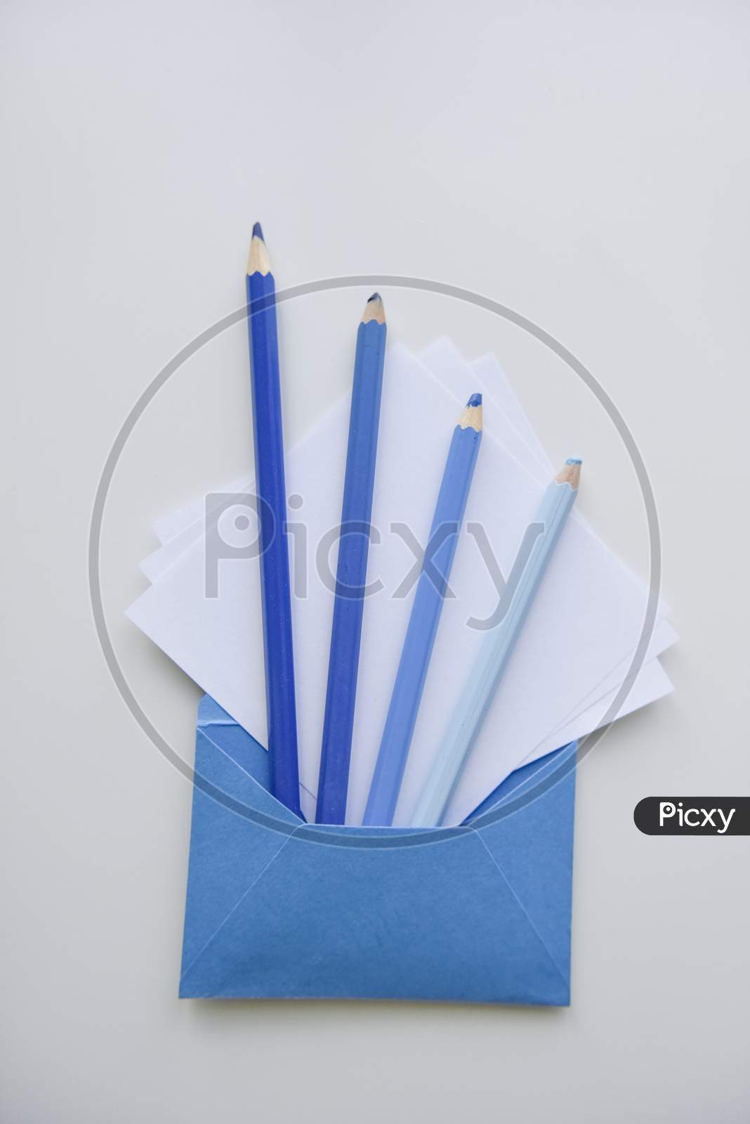 Selective Focus, Blue Pencils And White Papers Out Of The Blue Envelope