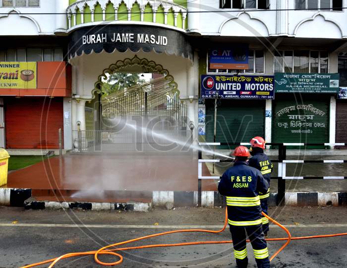 Assam State Fire and Emergency Service worker spray disinfectants at Burha Jame Masjid