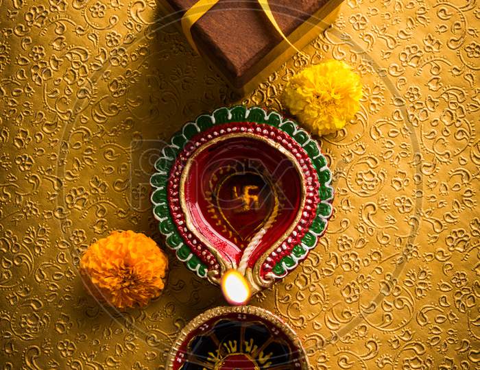 beautiful diwali diya or oil lamp with gifts