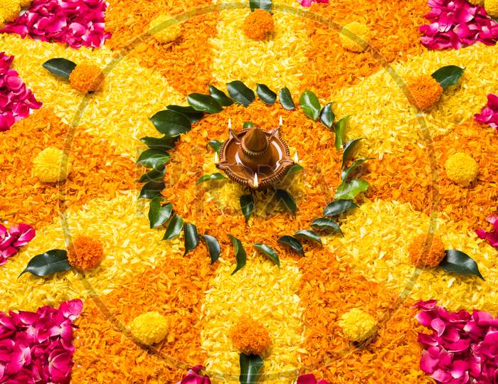 Flower Rangoli with Diya for diwali or Pongal