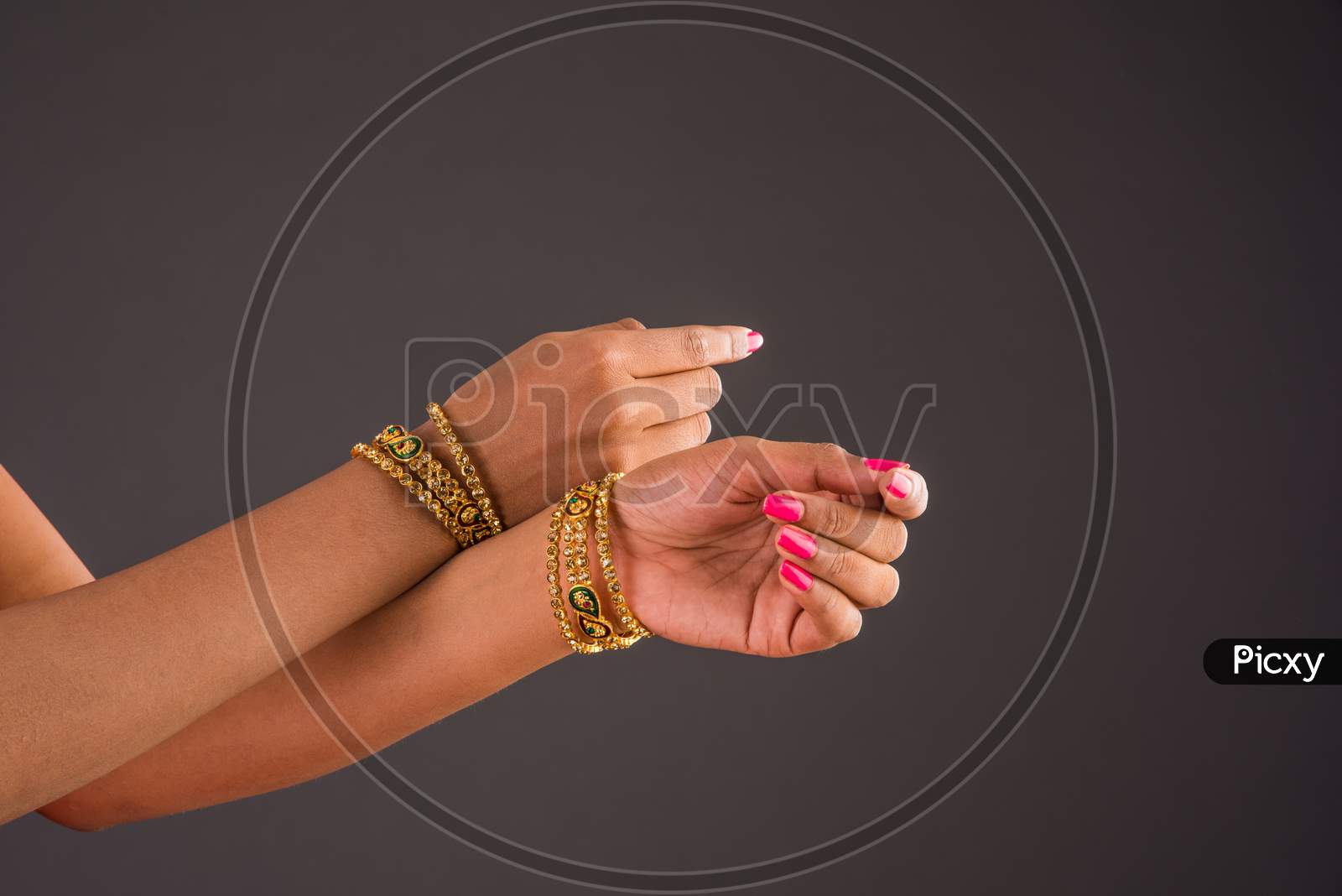 Closeup of girl wearing traditional designer gold bangles/bracelets