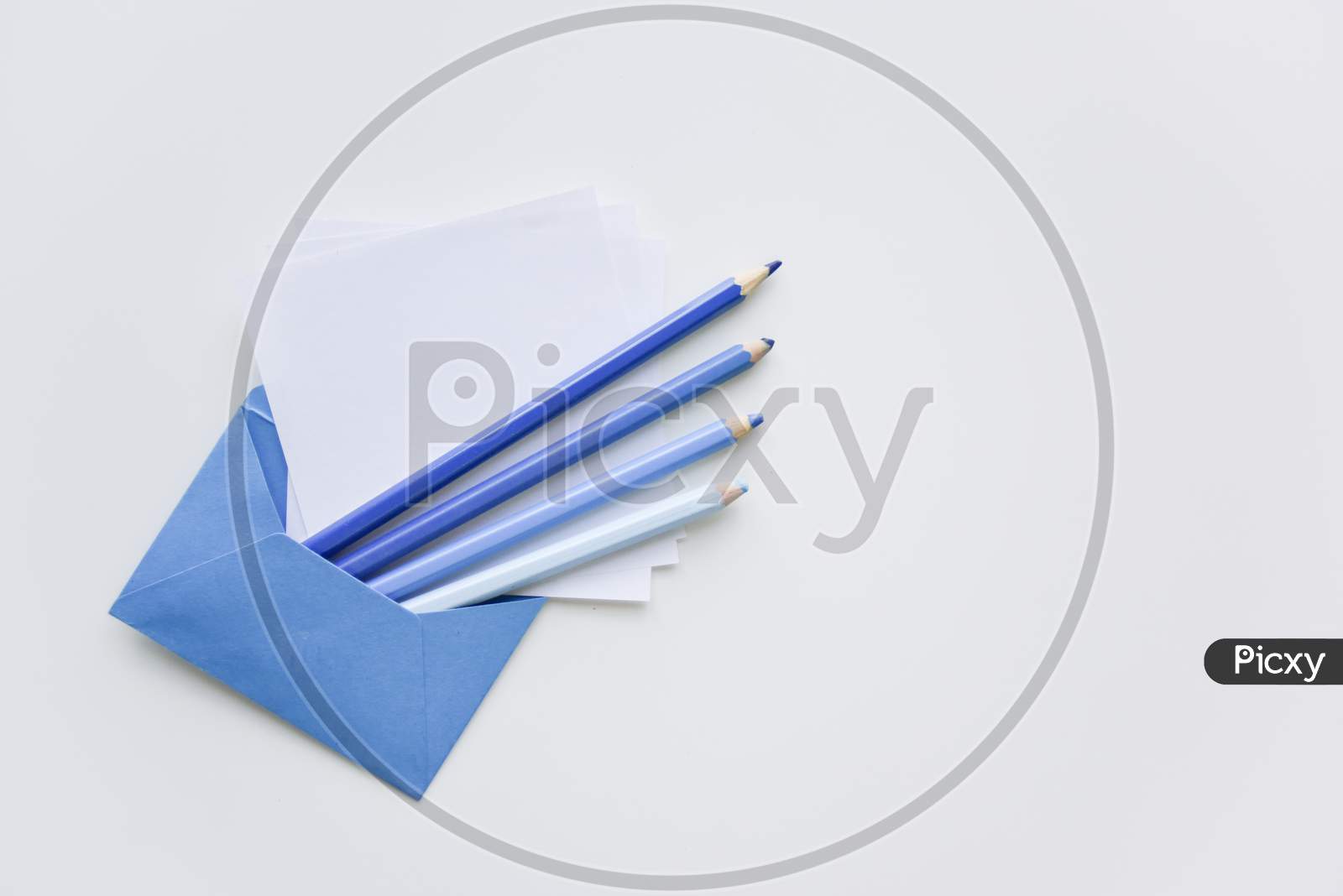 Selective Focus, Blue Pencils And White Papers Out Of The Blue Envelope With Copy Space On Top