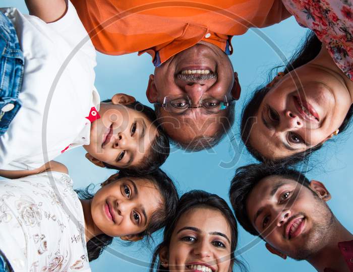 Indian family forming circle with heads touching each other