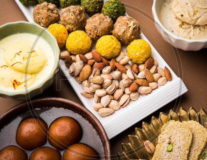 Indian sweet food group photo. Dry fruit laddu, kaju katli or kaju burfi, gajak or til papdi, rasmalai or Rasmalai