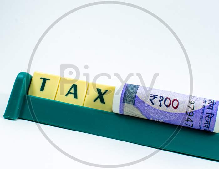 Tax word concept Image with new one hundred rupees of India