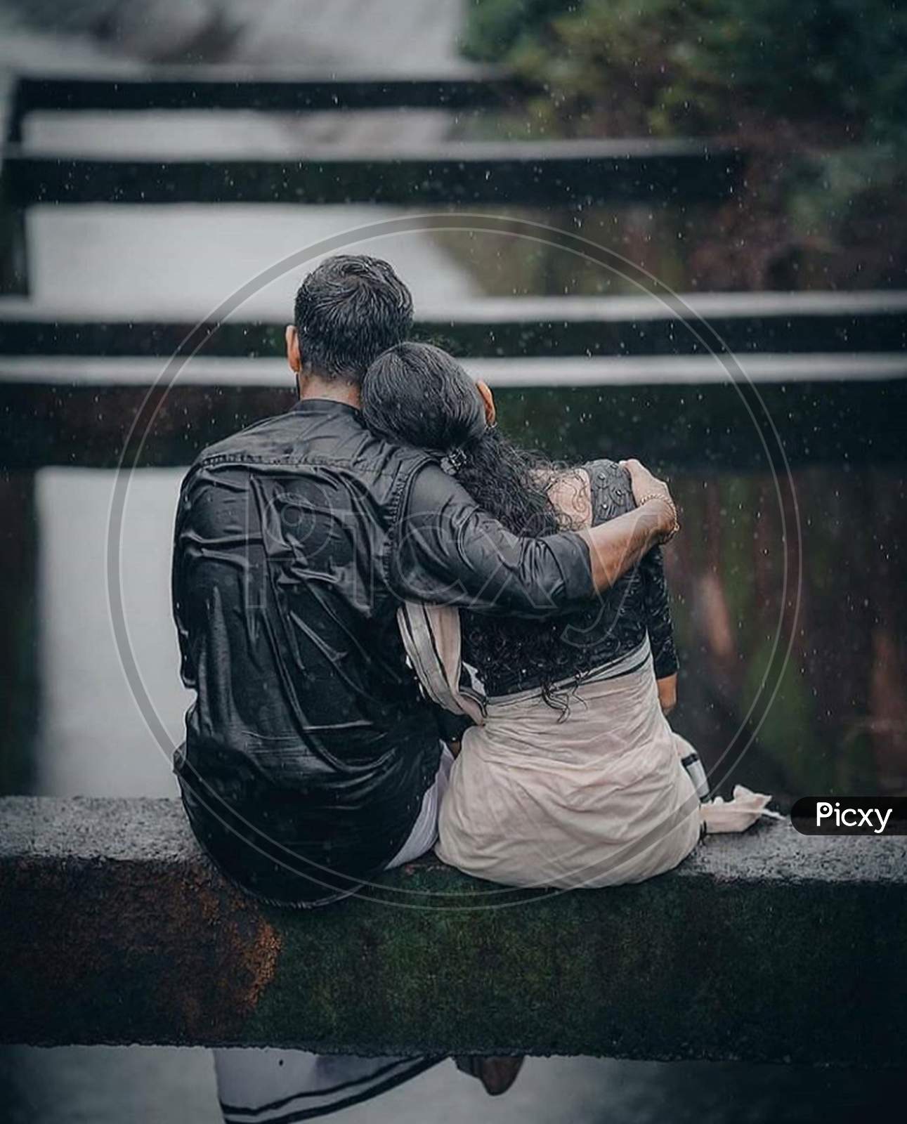 Couple sitting under rain shower