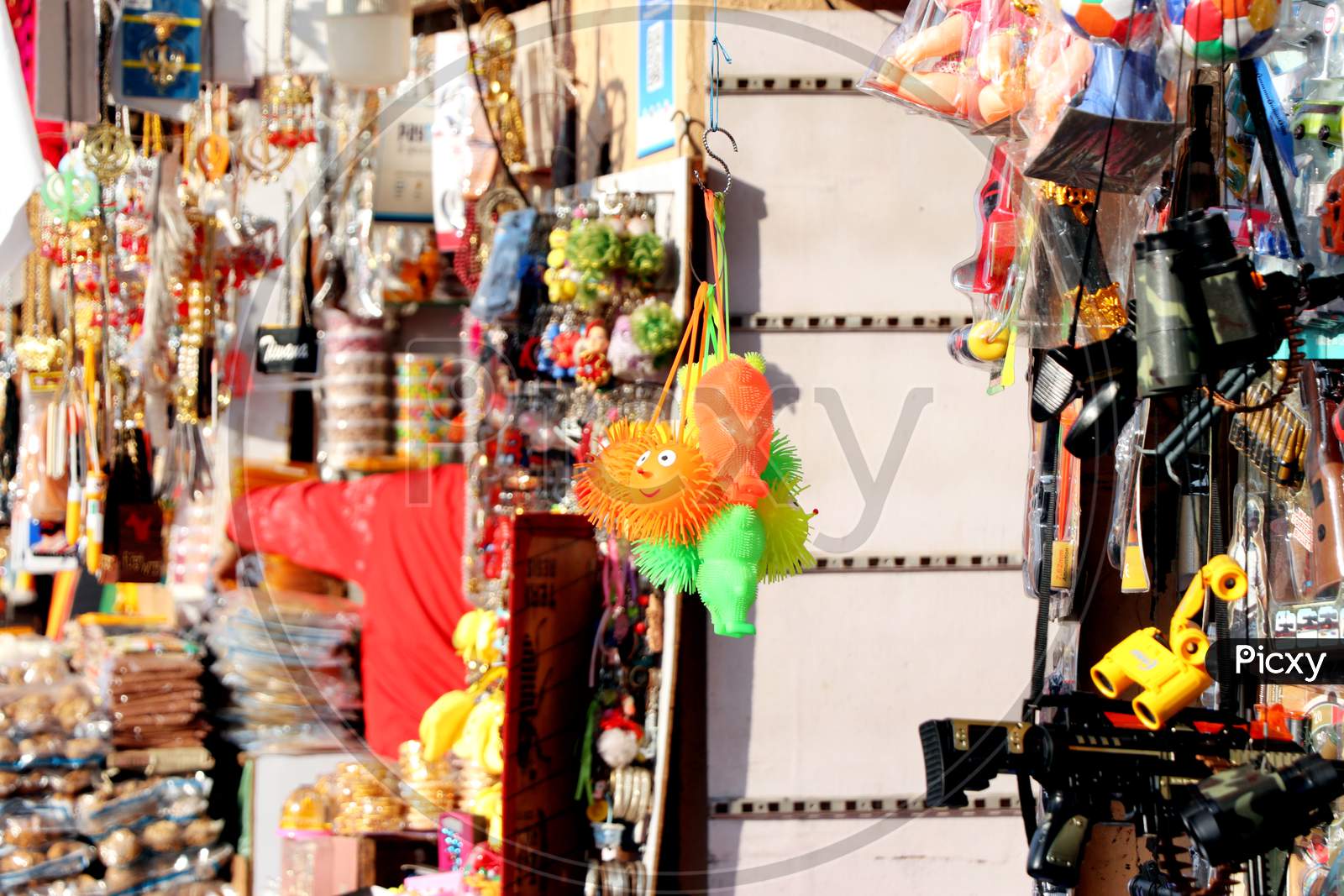 Amritsar, Punjab, India - December 03 2019: Toys And Accessories Hang In The Market Of Amritsar Golden Temple