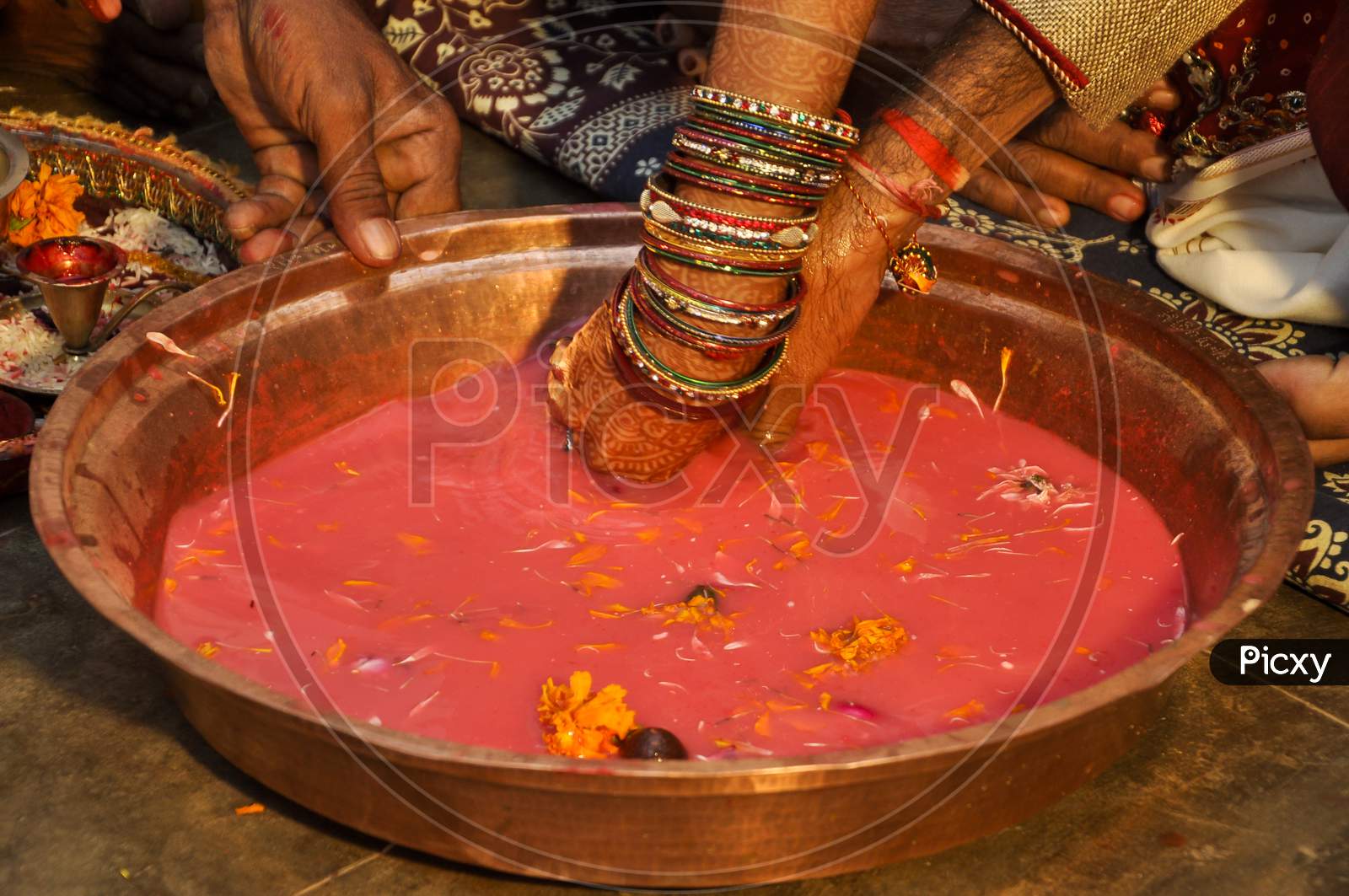 Indian Wedding Traditional Game Searching For Ring In Milk Plate.