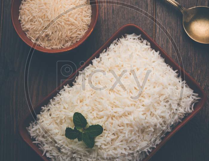 Cooked plain white basmati rice in terracotta bowl