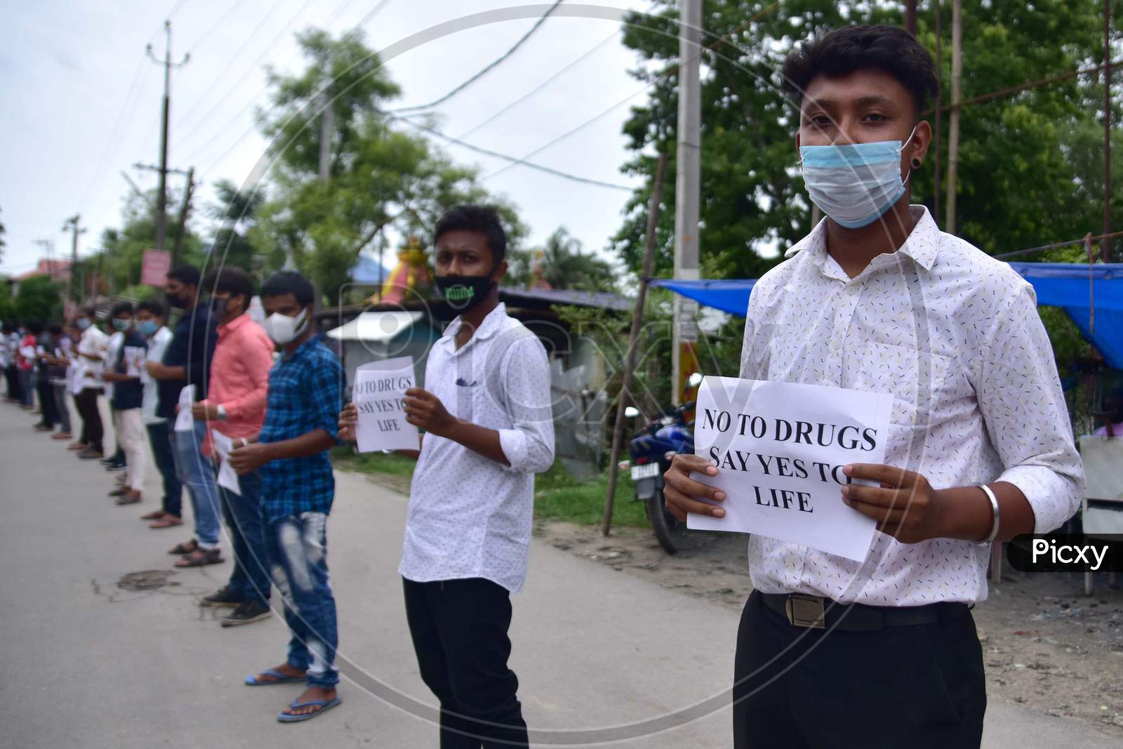 Members of All Assam Students Union(AASU) form a human chain to protest against drug abuse in Nagaon, Assam on July 10, 2020