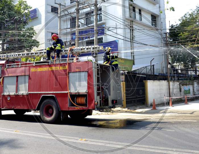 Fire-fighters spray disinfectants on streets