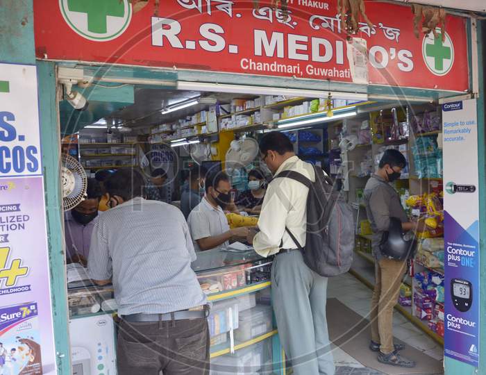 People buy medicines in a chemist shop