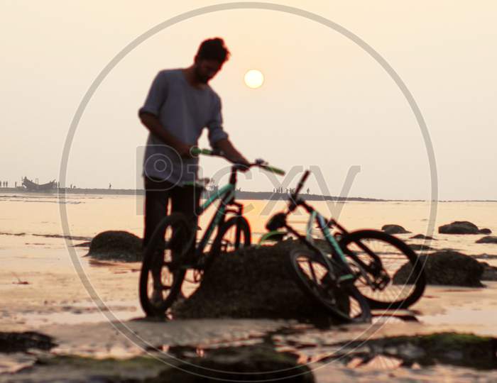 Man And Bicycle In Background Beautiful Sea Beach Nature Sunset.