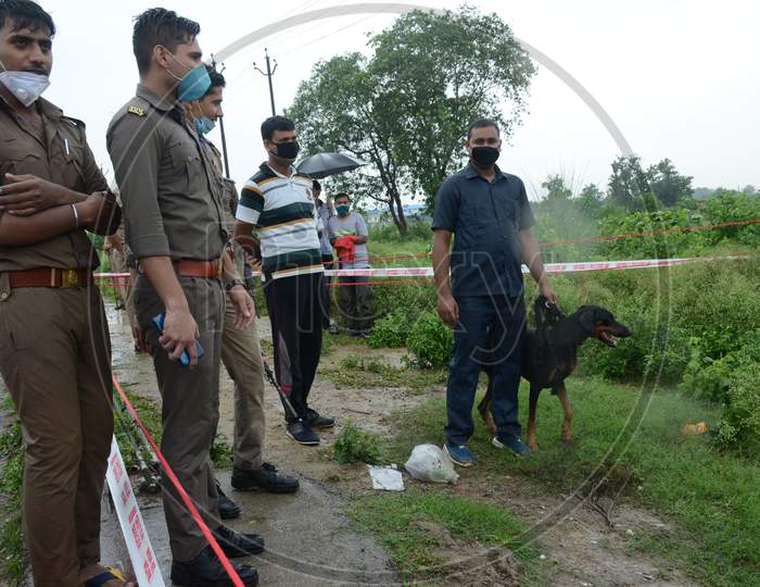 Police officials accompanied by a police dog at the site of the encounter of gangster Vikas Dubey who was killed when he tried to escape from police custody in Kanpur, Uttar Pradesh on July 10, 2020
