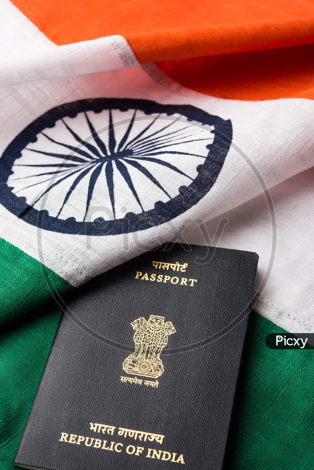 Indian passport placed over tricolour Flag