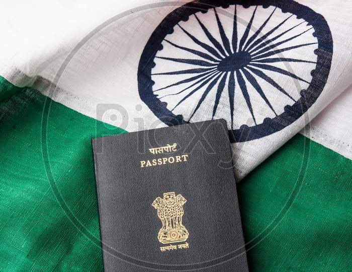 Indian passport placed over tricolour Flag