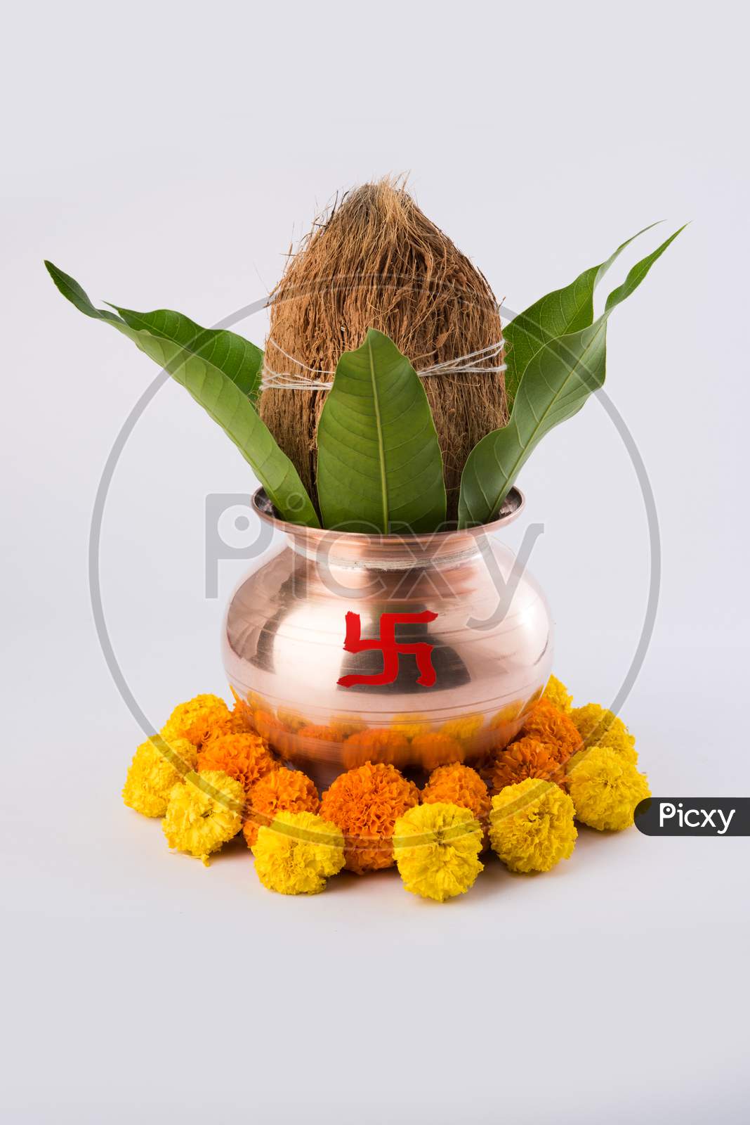 copper kalash with coconut and mango leaf with floral decoration