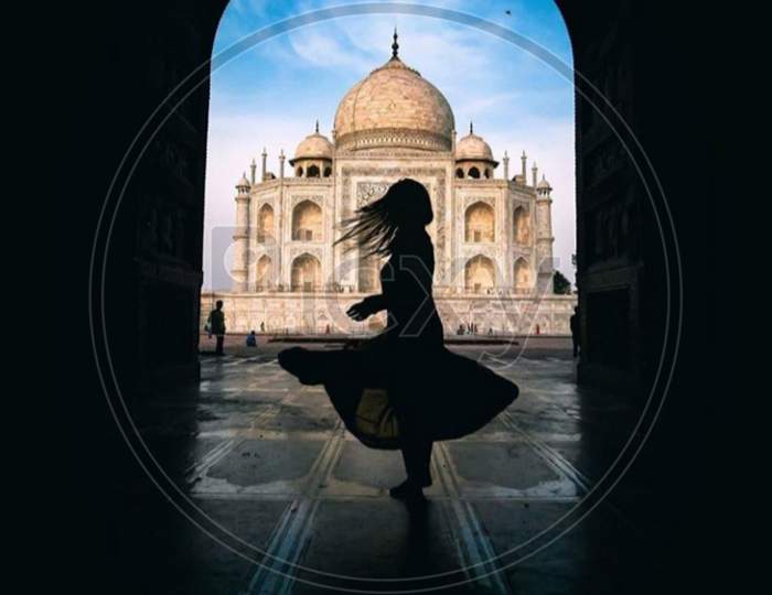 Girl dancing in front of Taj Mahal