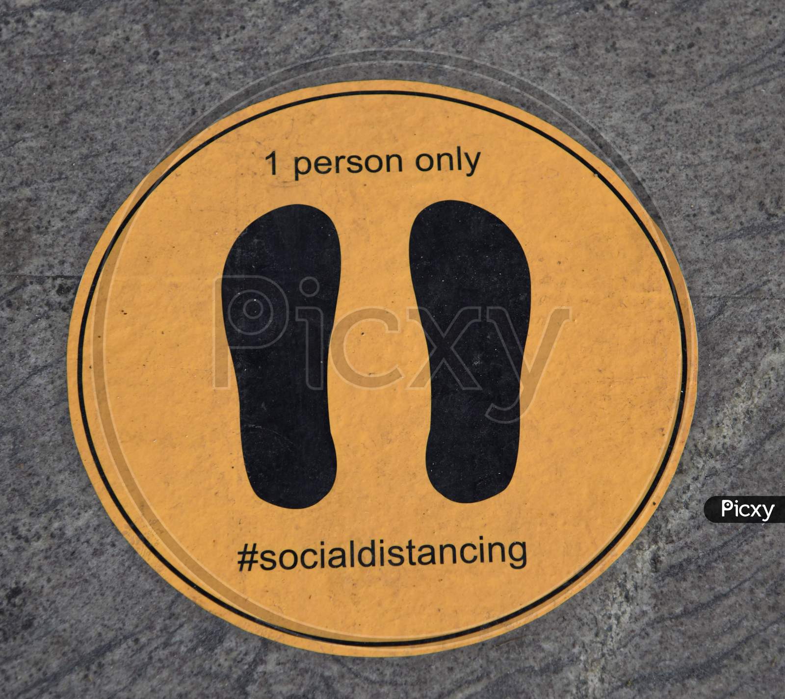 A Sticker Is Glued On The Floor To Help Maintain Social Distancing