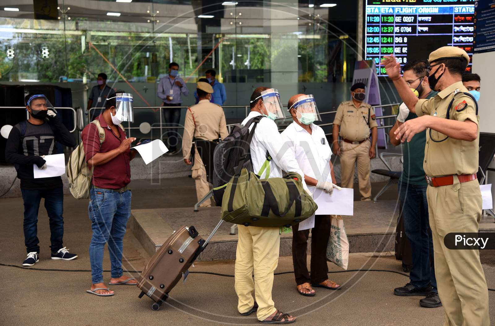 Passengers Wearing Protective Shields As They Arrive At Lokpriya Gopinath Bordoloi International Airport