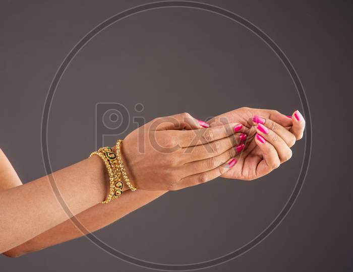 Closeup of girl wearing traditional designer gold bangles/bracelets