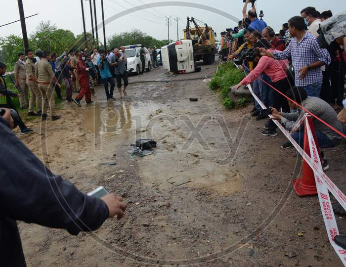 Police officials and bystanders at the site of encounter where gangster Vikas Dubey was killed when he tried to escape from police custody in Kanpur, Uttar Pradesh on July 10, 2020