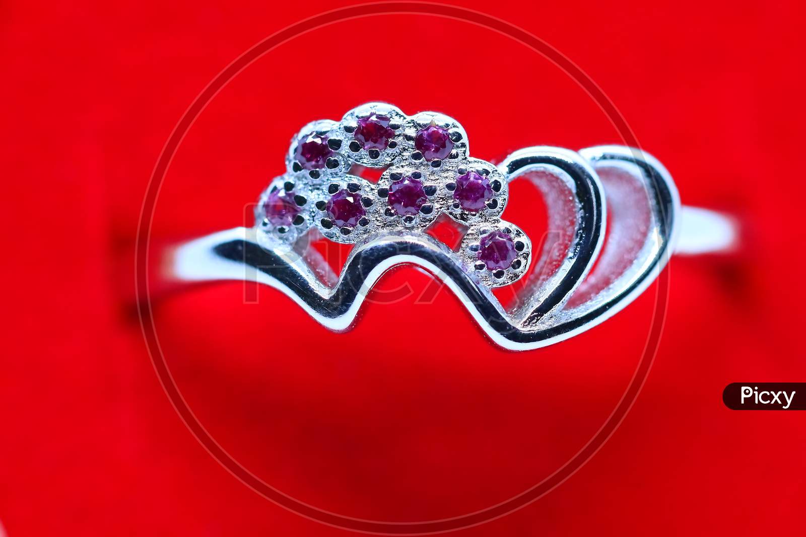 Silver Ring With Red Background