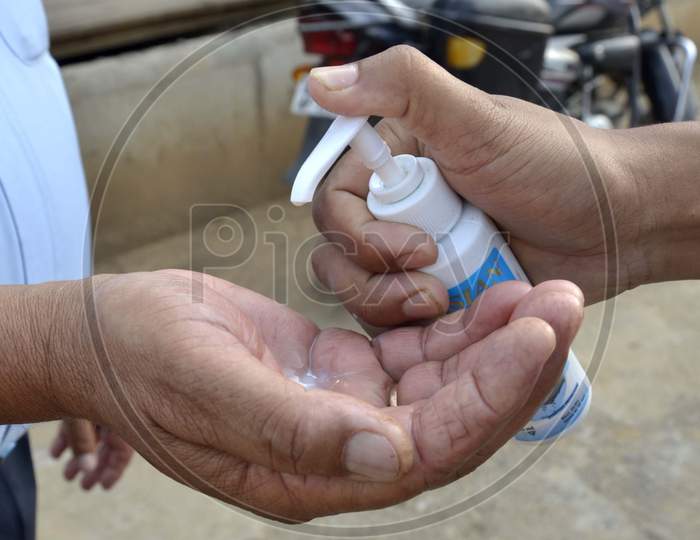 A Traffic police giving hand sanitizer to his colleague