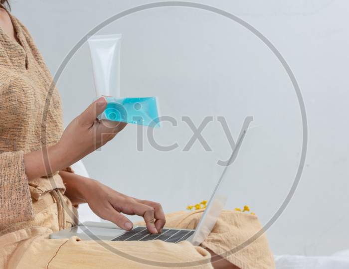 The Women Is Washing With Hands Gel While Working In The Living Room