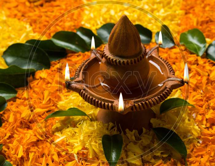 Flower Rangoli with Diya for diwali or Pongal