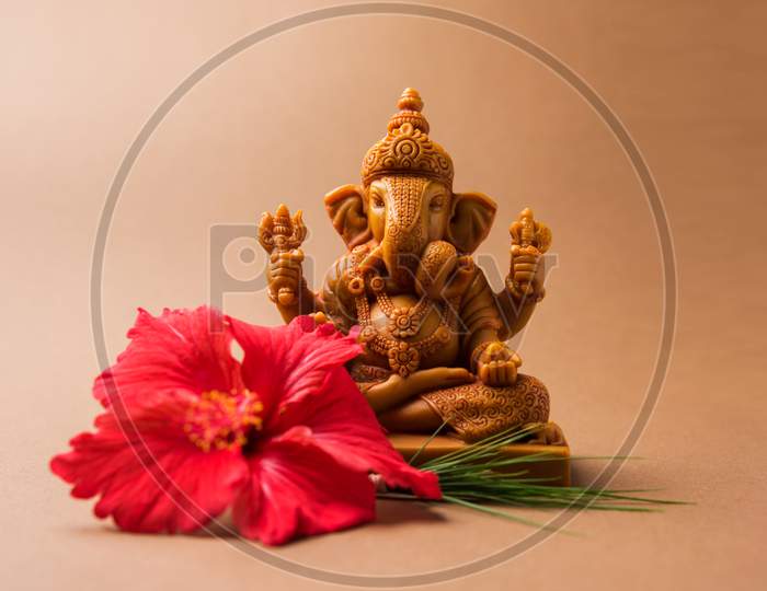 lord ganesha idol with pooja or puja thali, bundi laddu/modak, durva and hibiscus or jasvand flower