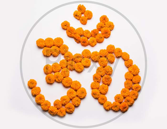 Stock photo of word Aum or om made using marigold flower arrangement