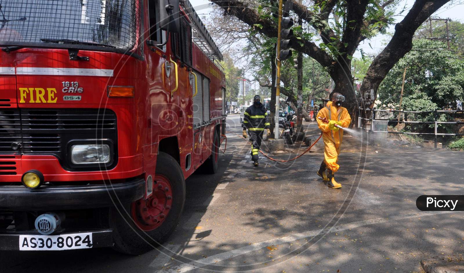 Firefighters spray disinfectants on streets