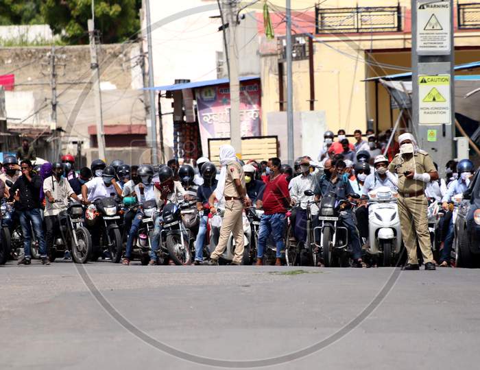 Police personnel stop the traffic to allow health workers carry the dead body of a person who died due to coronavirus infection in Ajmer, Rajasthan on July 08, 2020