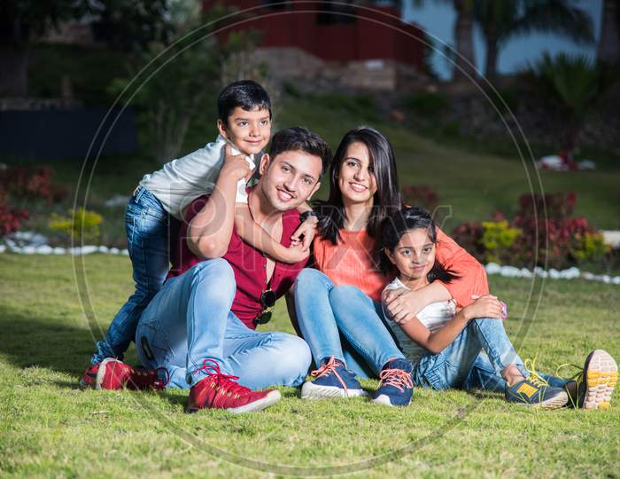 Portrait of Happy Indian/Asian Family sitting outdoor