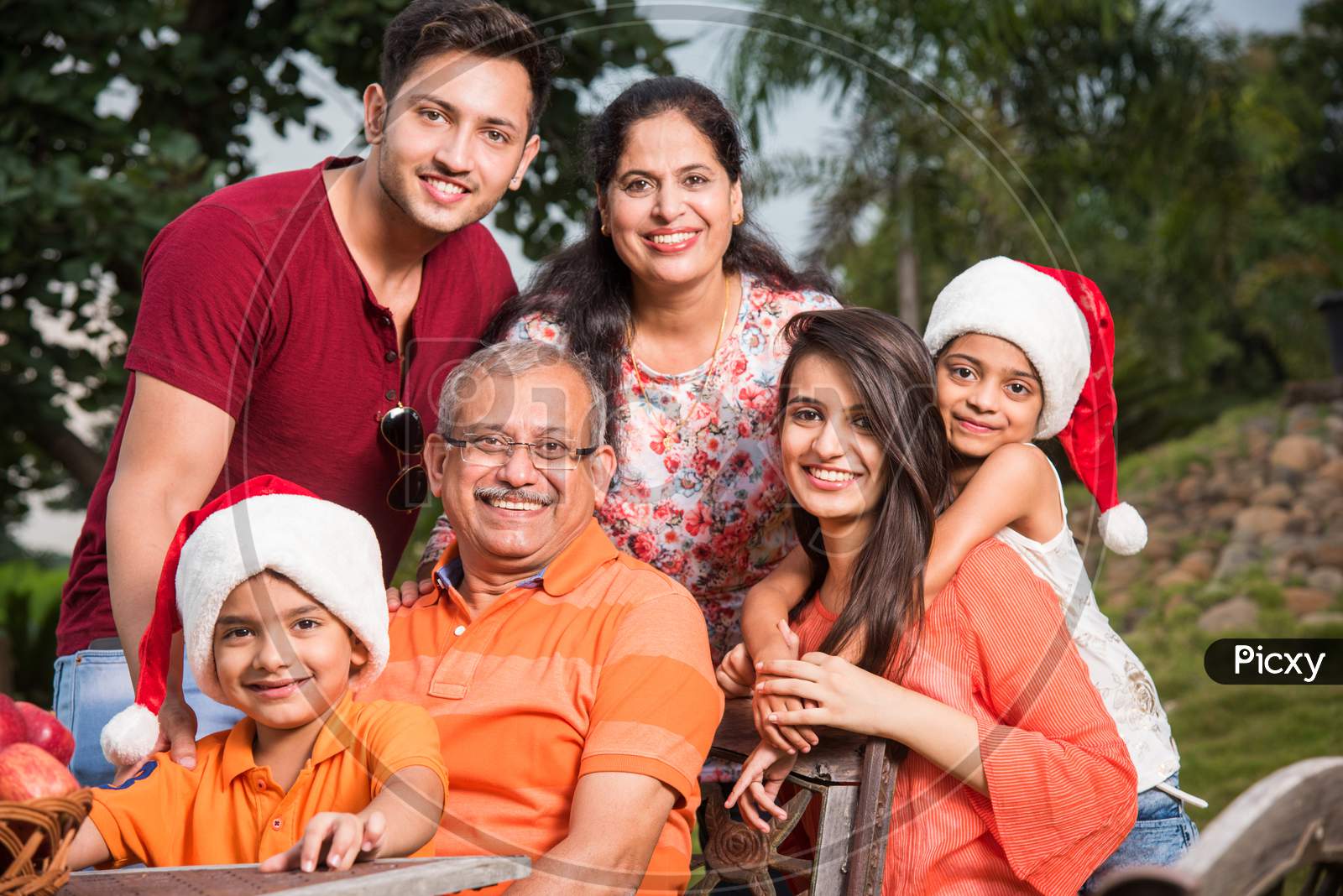 Indian family sitting outdoor and celebrating christmas