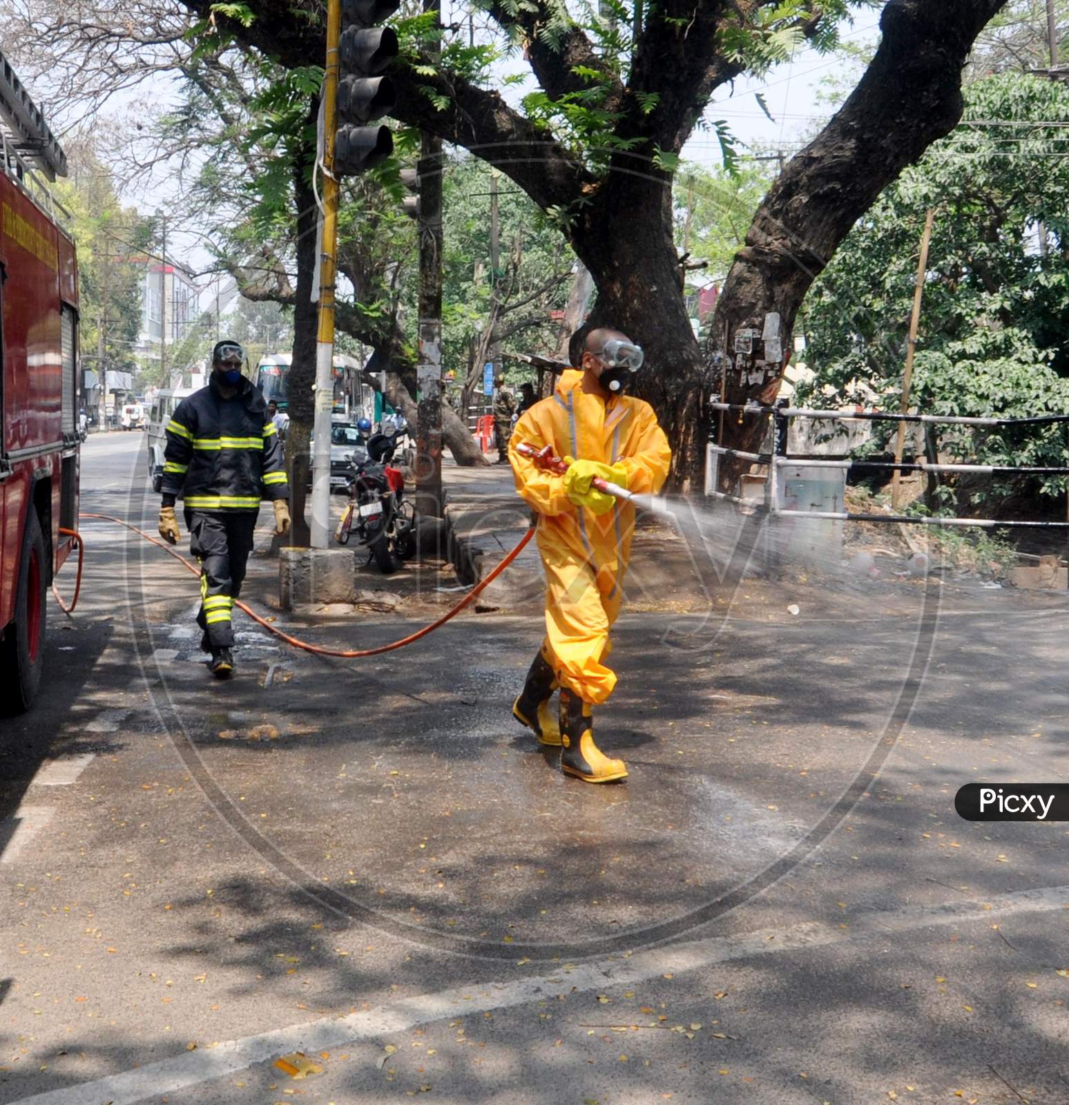 Firefighters spray disinfectants on streets