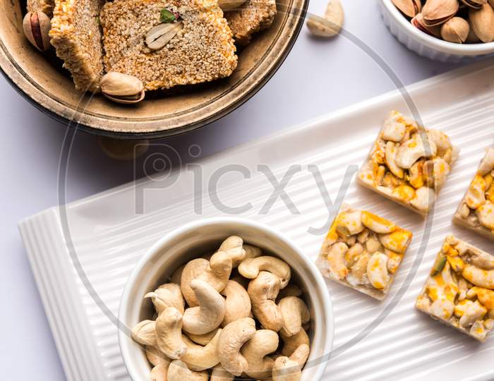 Indian sweet food group photo. Dry fruit laddu, kaju katli or kaju burfi, gajak or til papdi, rasmalai or Rasmalai