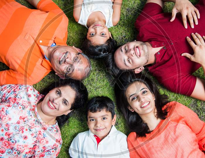 Indian family forming circle with heads touching each other