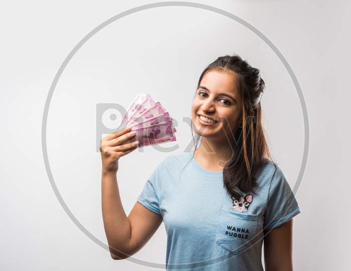 beautiful young girl holding money fan