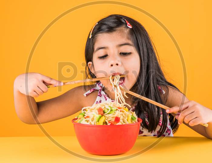 Small Girl eating chinese noodles