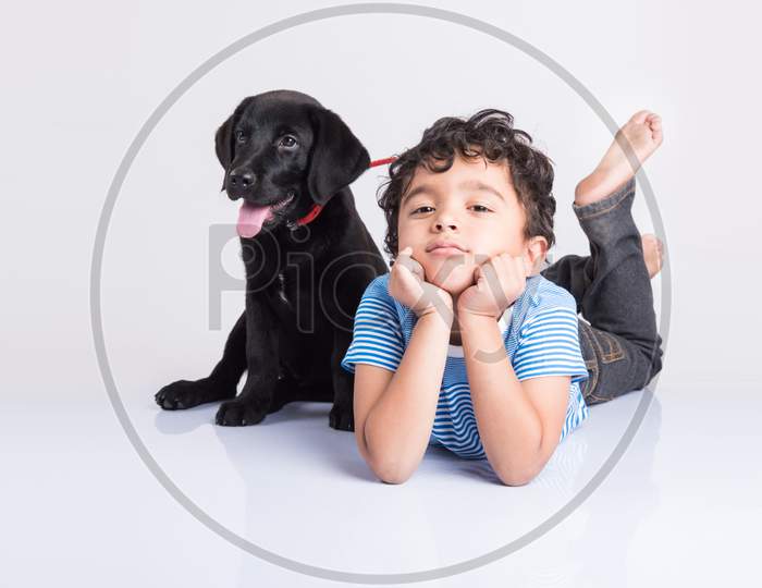 Cute little indian boy with pet dog/puppy
