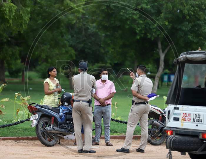 Delhi police personnel question people visiting India Gate for not wearing a mask in New Delhi on July 07, 2020